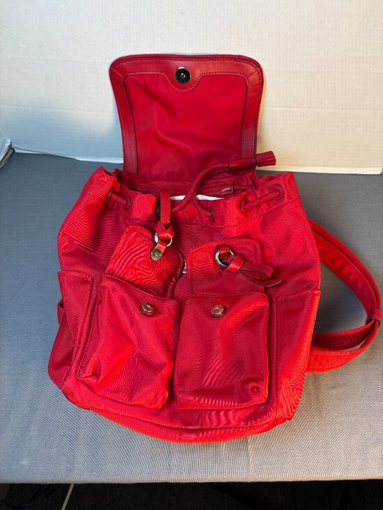 Kate Spade Carley Flap Backpack w/ Pockets, Drawstring, Nylon.- RED